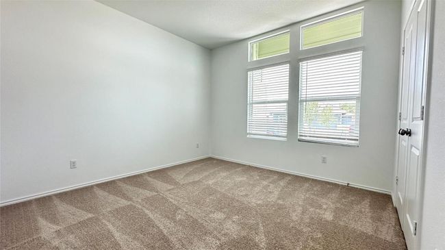 Carpeted spare room featuring baseboards and plenty of natural light | Image 9