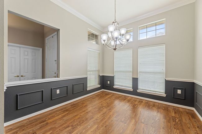 Unfurnished dining area featuring a chandelier, ornamental molding, and wood finished floors | Image 7
