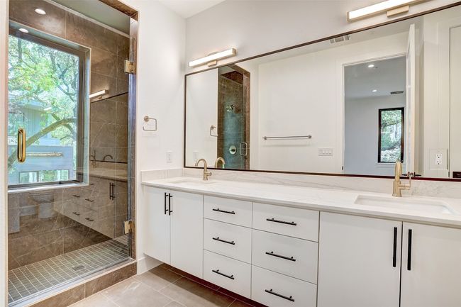 Full bathroom with double vanity, a stall shower, tile patterned flooring, and recessed lighting | Image 13