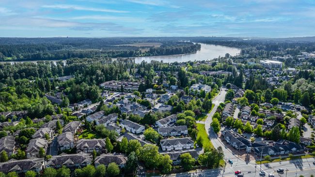 Aerial view of property and surrounding area featuring a forest, a nearby body of water, and nearby suburban area | Image 36