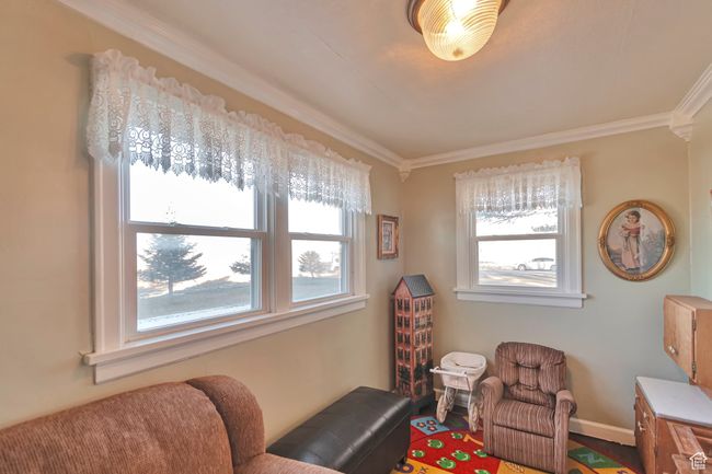 Living area with plenty of natural light and crown molding | Image 23