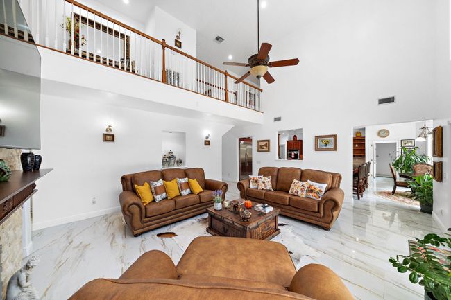 Spacious living room with an open layout and balcony view. | Image 6