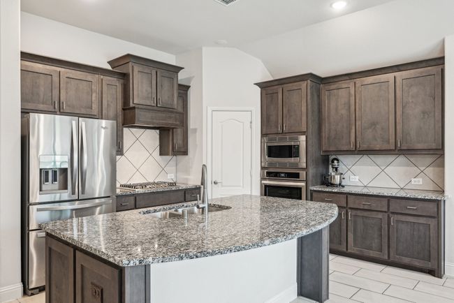 Kitchen with dishwasher, a sink, granite counters, a kitchen island with sink, and recessed lighting | Image 18