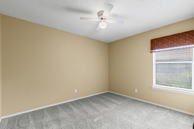Two additional bedrooms are generously sized with walk-in closets. | Image 17