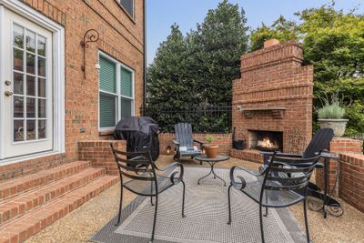 PERFECT BACKYARD FOR ENTERTAINING!!!! Real wood burning fireplace on large outdoor patio with gas grill hookup... french doors lead right into living room/ kitchen area indoors. Imagine fall nights cozied up by this fireplace making s'mores!! | Image 2