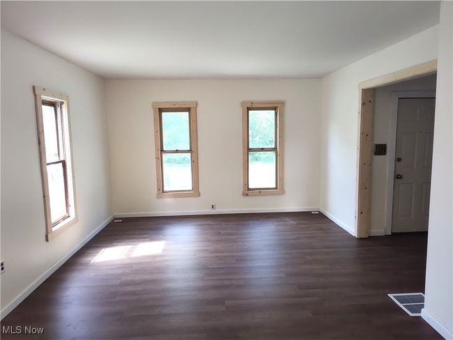 Spare room with dark wood finished floors and baseboards | Image 19