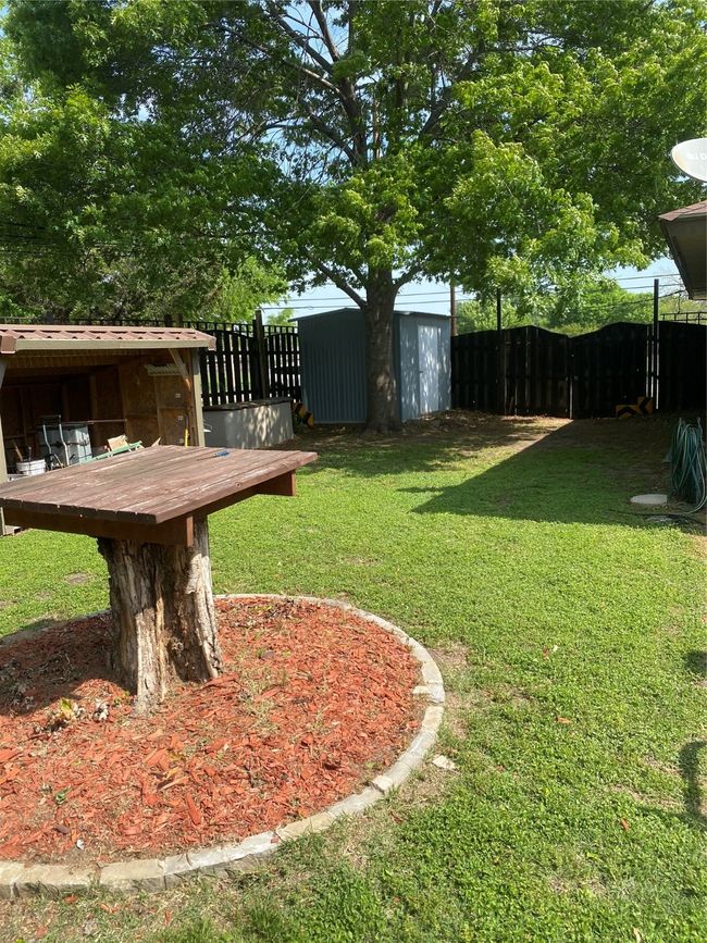 View of yard featuring fence, an outbuilding, and a shed | Image 24