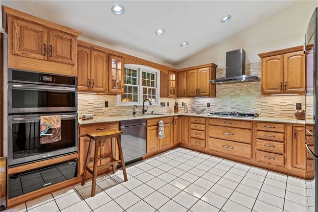 Updated Kitchen with Samsung Appliances, Cambria quartz countertops and stone backsplash. | Image 10