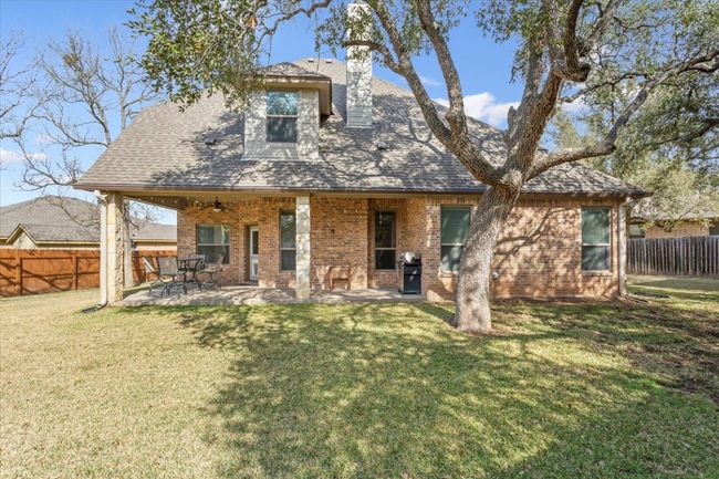 Back of house with a yard, a patio area, ceiling fan, and fence | Image 35