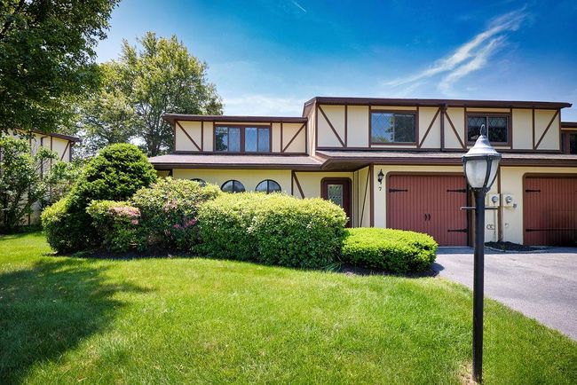 Tudor-style house featuring a front yard, stucco siding, and driveway | Image 31