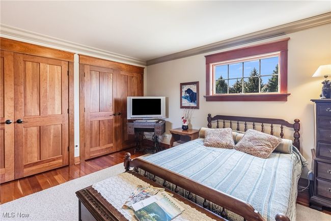 Bedroom with crown molding and wood finished floors | Image 35