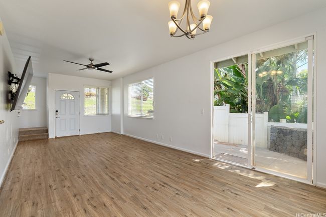 How would you use this spacious living room? On the right is the sliding door to your shady patio area. On the left is the front door of the home & hallway leading to the upstairs bedrooms. | Image 8
