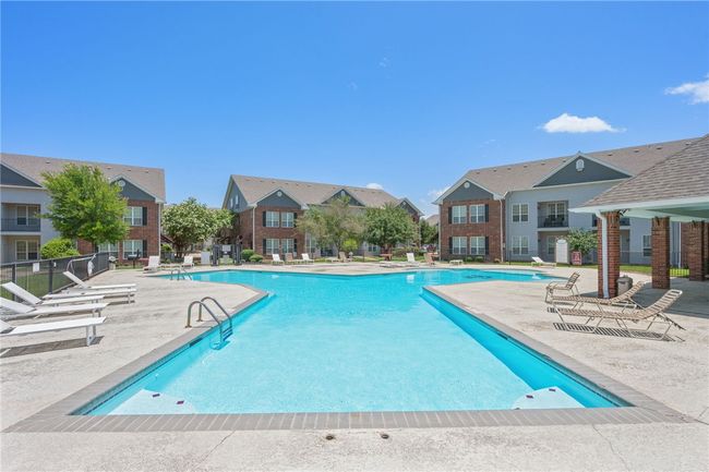 Community pool featuring a patio area and a residential view | Image 15