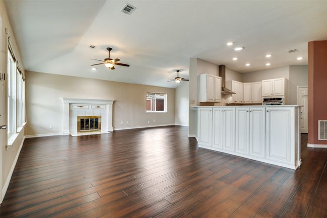 Kitchen with open floor plan, vaulted ceiling, recessed lighting, ceiling fan, and a peninsula | Image 5