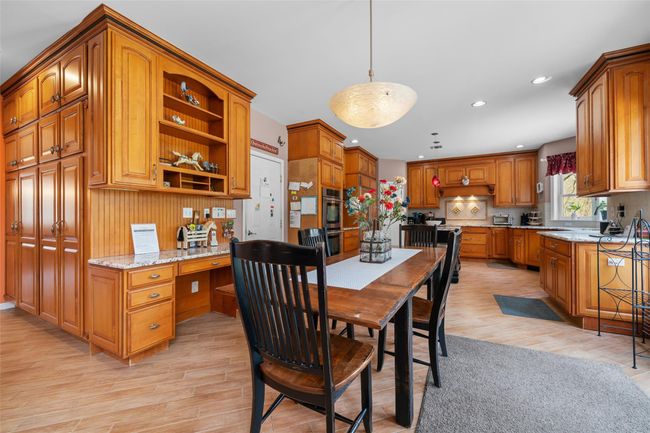 Dining area with built in study area, recessed lighting, and light wood-style flooring | Image 6