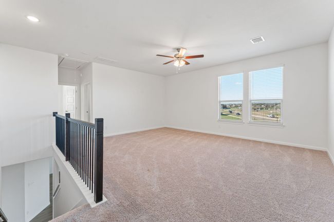 Empty room featuring visible vents, attic access, baseboards, and carpet floors | Image 14