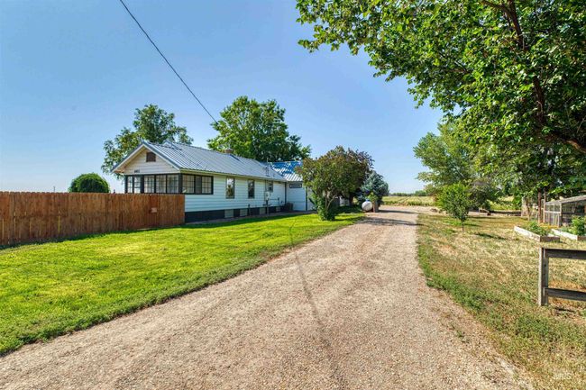 View of front of property featuring dirt driveway and a metal roof | Image 35