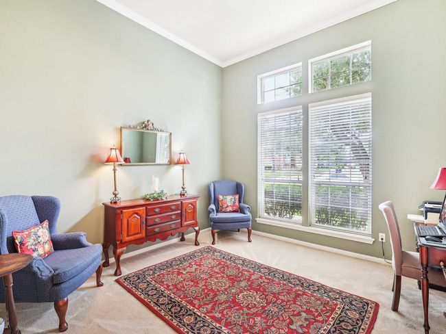 Carpeted home office featuring crown molding and baseboards | Image 14