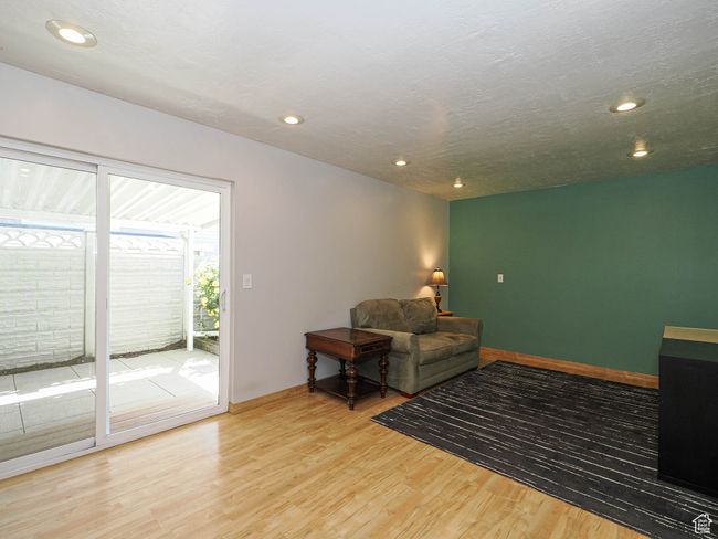 Living area with wood finished floors, recessed lighting, and baseboards | Image 13