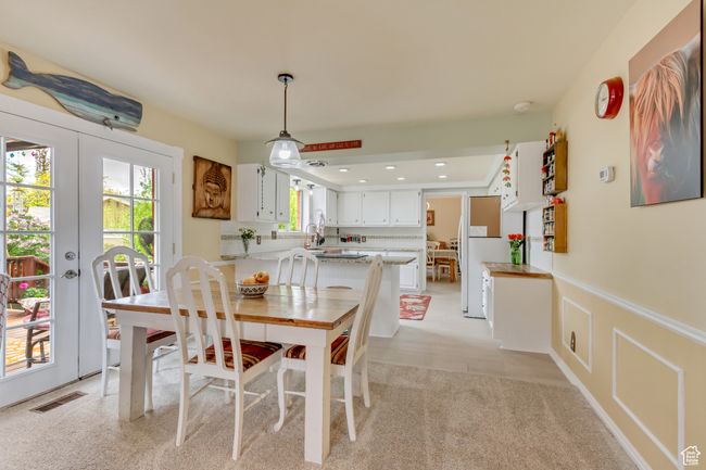 Dining area featuring french doors, visible vents, and a wainscoted wall | Image 15