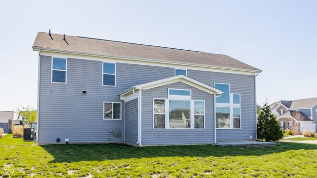back of property featuring a lawn and central AC | Image 47