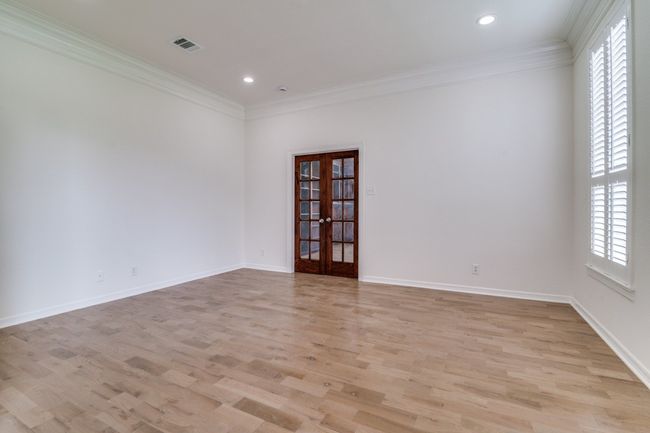 Empty room featuring french doors, light wood-type flooring, crown molding, recessed lighting, and baseboards | Image 4