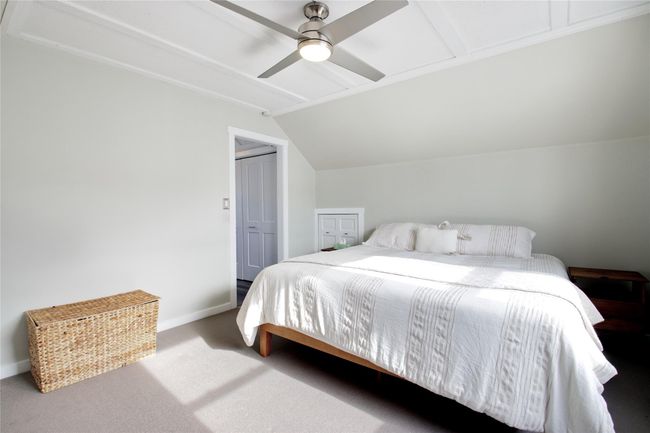Carpeted bedroom with lofted ceiling, baseboards, and a ceiling fan | Image 17