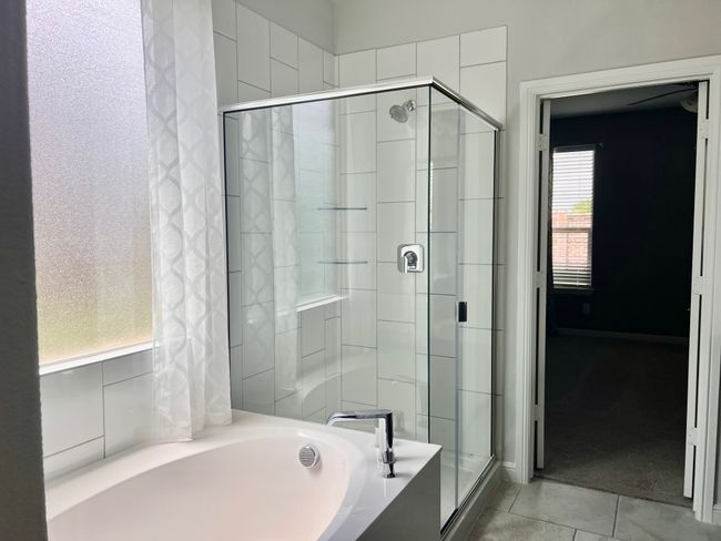 Full bathroom featuring a shower stall, a garden tub, and tile patterned floors | Image 14
