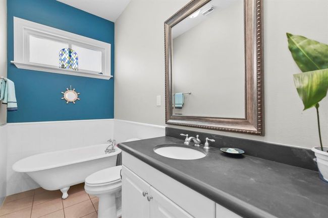 Discover the charm of the downstairs full bath, featuring a classic clawfoot tub. | Image 28