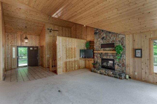 Massive full height field stone fireplace provides warmth and beauty to this space! | Image 12
