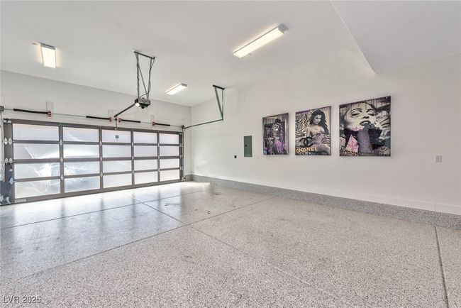 Garage with baseboards, a garage door opener, and electric panel | Image 19