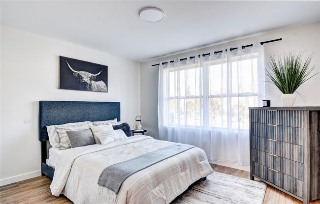 Bedroom with baseboards and wood finished floors | Image 19