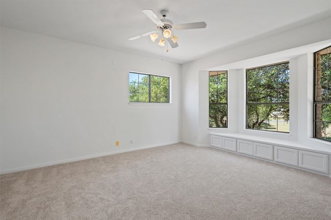 Spare room featuring light carpet, baseboards, and ceiling fan | Image 28