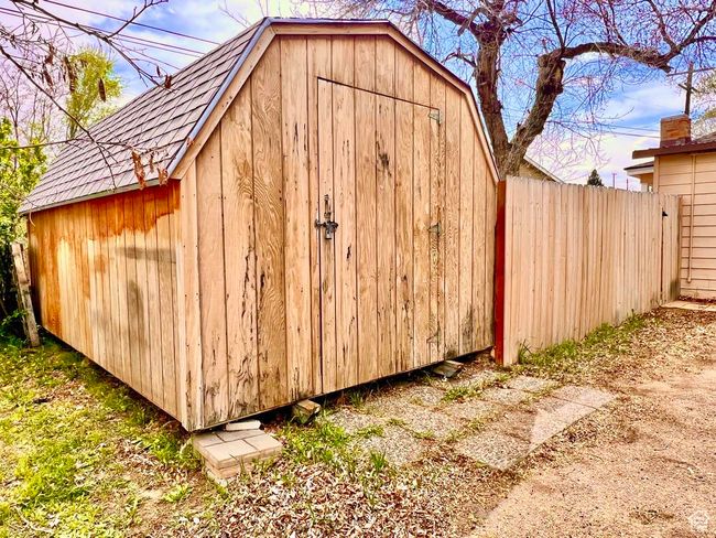 View of outdoor structure featuring an outbuilding and fence | Image 29