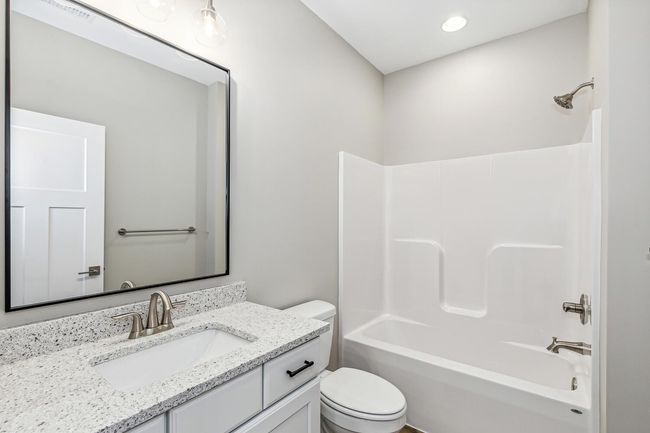 Full bathroom with washtub / shower combination, vanity, and toilet | Image 13