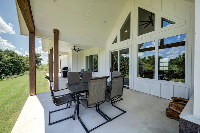 View of terrace with ceiling fan and area for grilling | Image 31