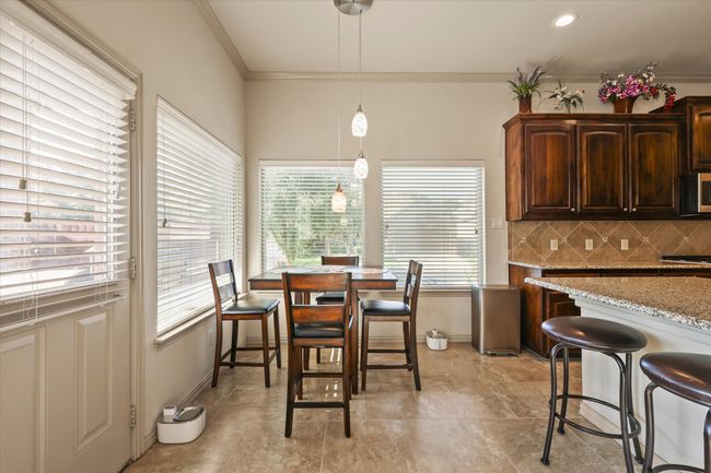 Breakfast nook with view of serene backyard | Image 11
