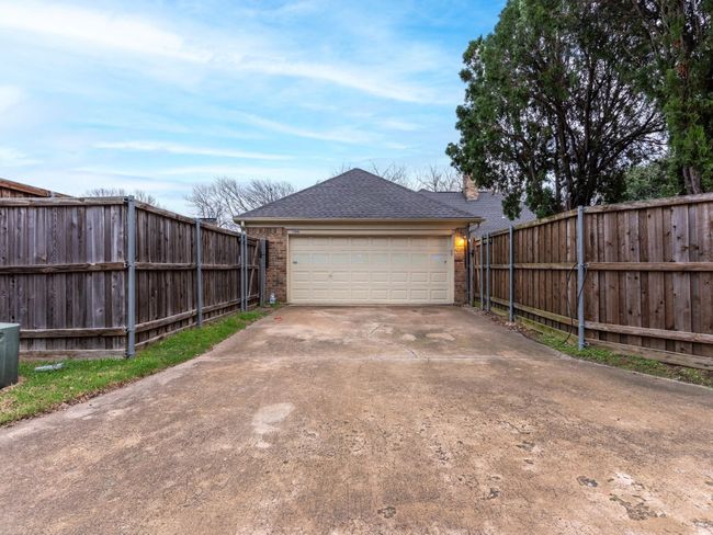 Garage with fence and concrete driveway | Image 28