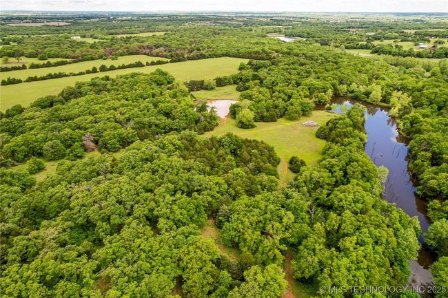 Drone / aerial view of a large body of water and a heavily wooded area | Image 55