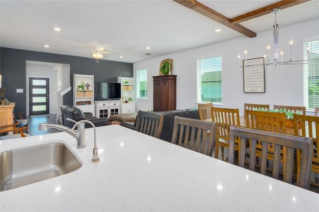Kitchen featuring a chandelier, healthy amount of natural light, a ceiling fan, pendant lighting, and recessed lighting | Image 5