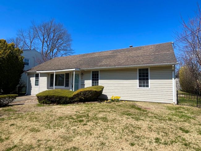Ranch-style home with roof with shingles, fence, and a front lawn | Image 24