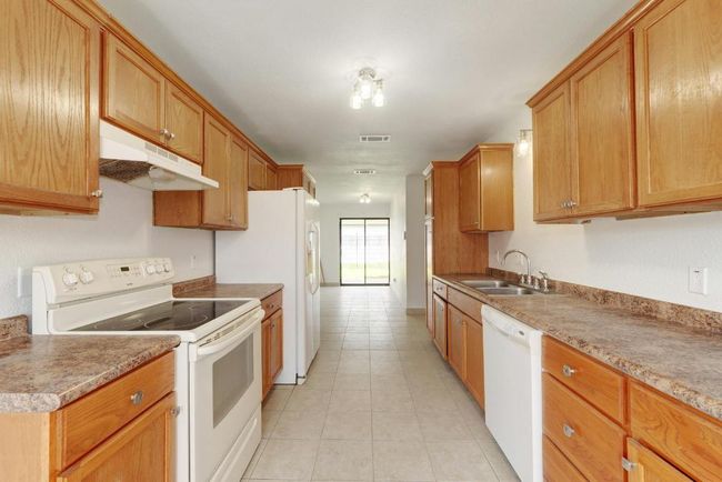 Kitchen Look to Dining Area and to Patio | Image 13