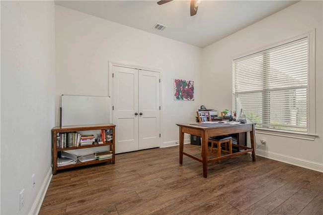 Office space featuring visible vents, ceiling fan, wood finished floors, and baseboards | Image 24