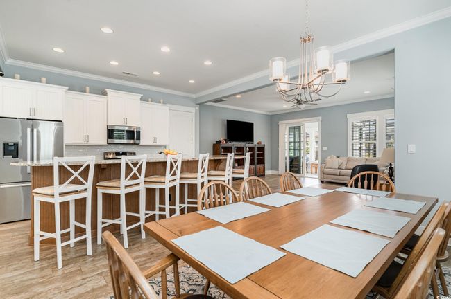 Dining room with light wood-style flooring, an inviting chandelier, recessed lighting, and ornamental molding | Image 14