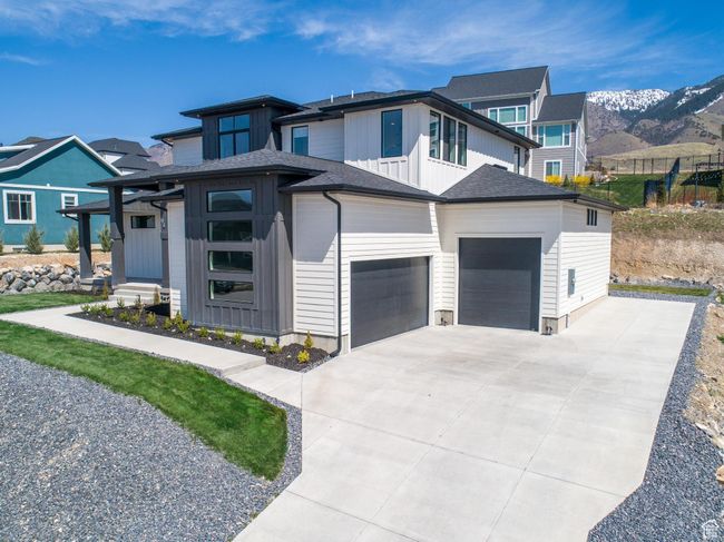 Prairie-style house with an attached garage, board and batten siding, driveway, and a mountain view | Image 6