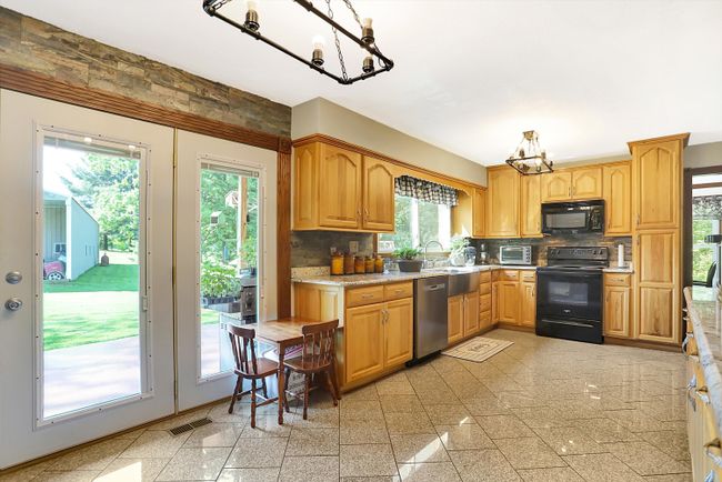 Kitchen with granite counter tops and floors | Image 8