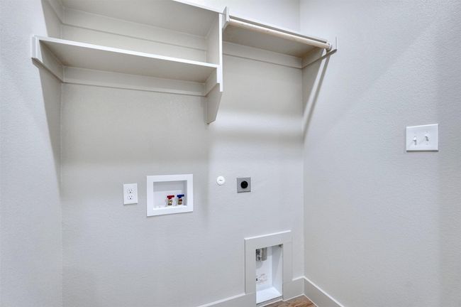 Laundry room featuring laundry area, electric dryer hookup, washer hookup, hookup for a gas dryer, and baseboards | Image 12