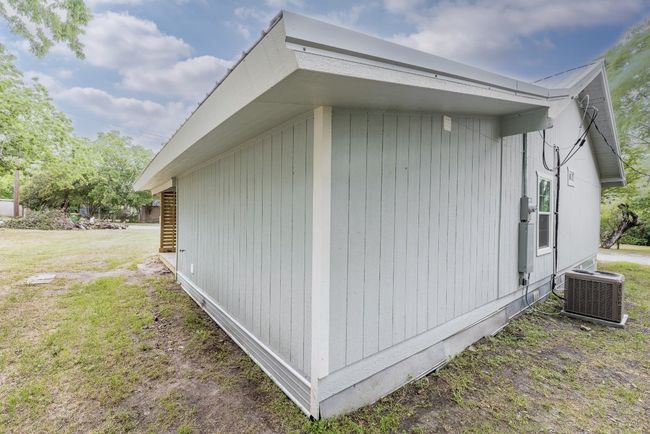 View of property exterior featuring a lawn and central AC | Image 32