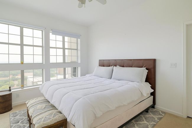 Bedroom with carpet floors, multiple windows, and ceiling fan | Image 8