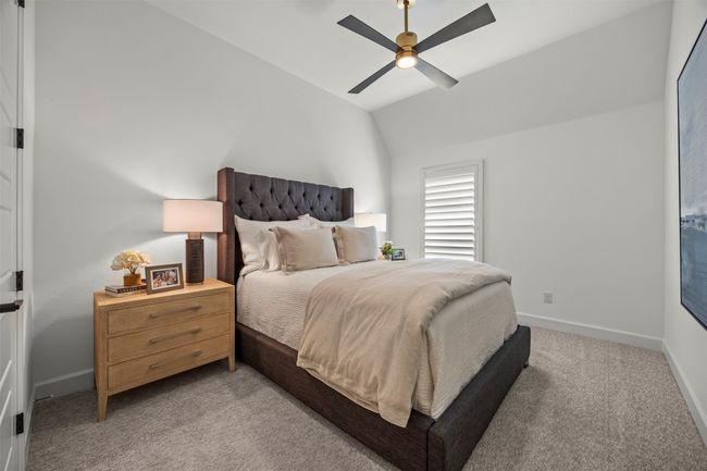 Bedroom featuring light carpet, vaulted ceiling, and ceiling fan | Image 27